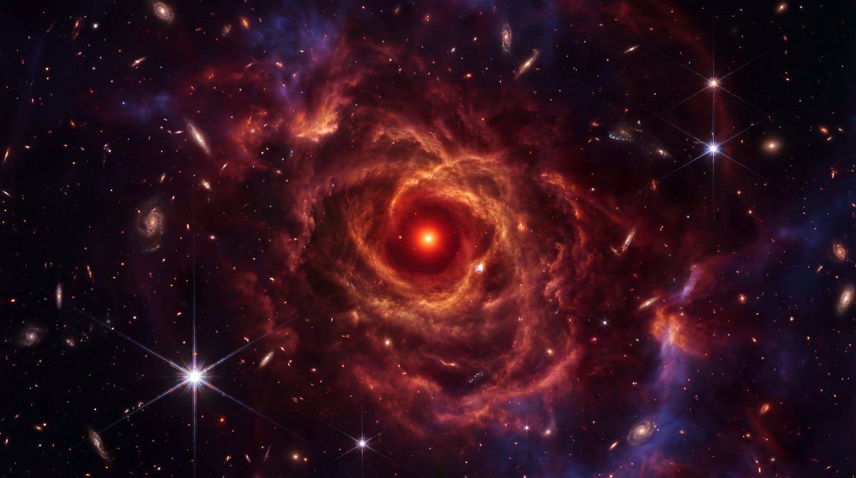 A vivid red black hole shrouded in swirling gas clouds against a backdrop of distant stars and galaxies in deep space.