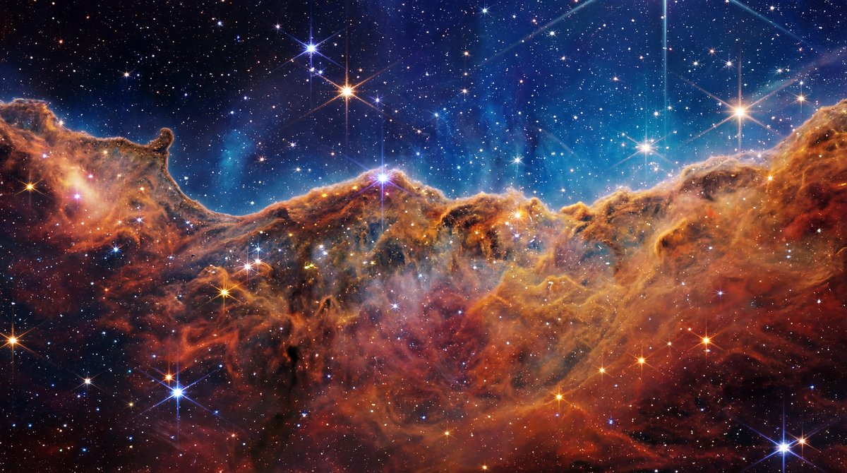 Vibrant deep space nebula with thousands of stars and faint radio waves rippling past a small blue planet.