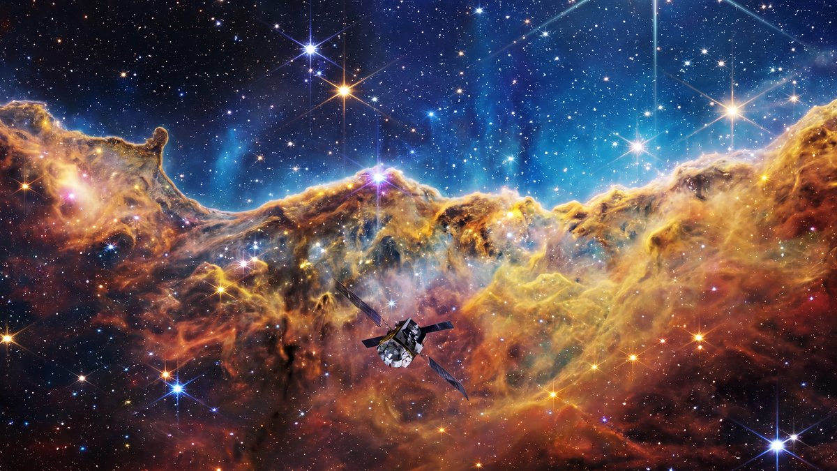 Vibrant, iridescent nebula with glowing gas clouds and dense star clusters set against a deep black space background.